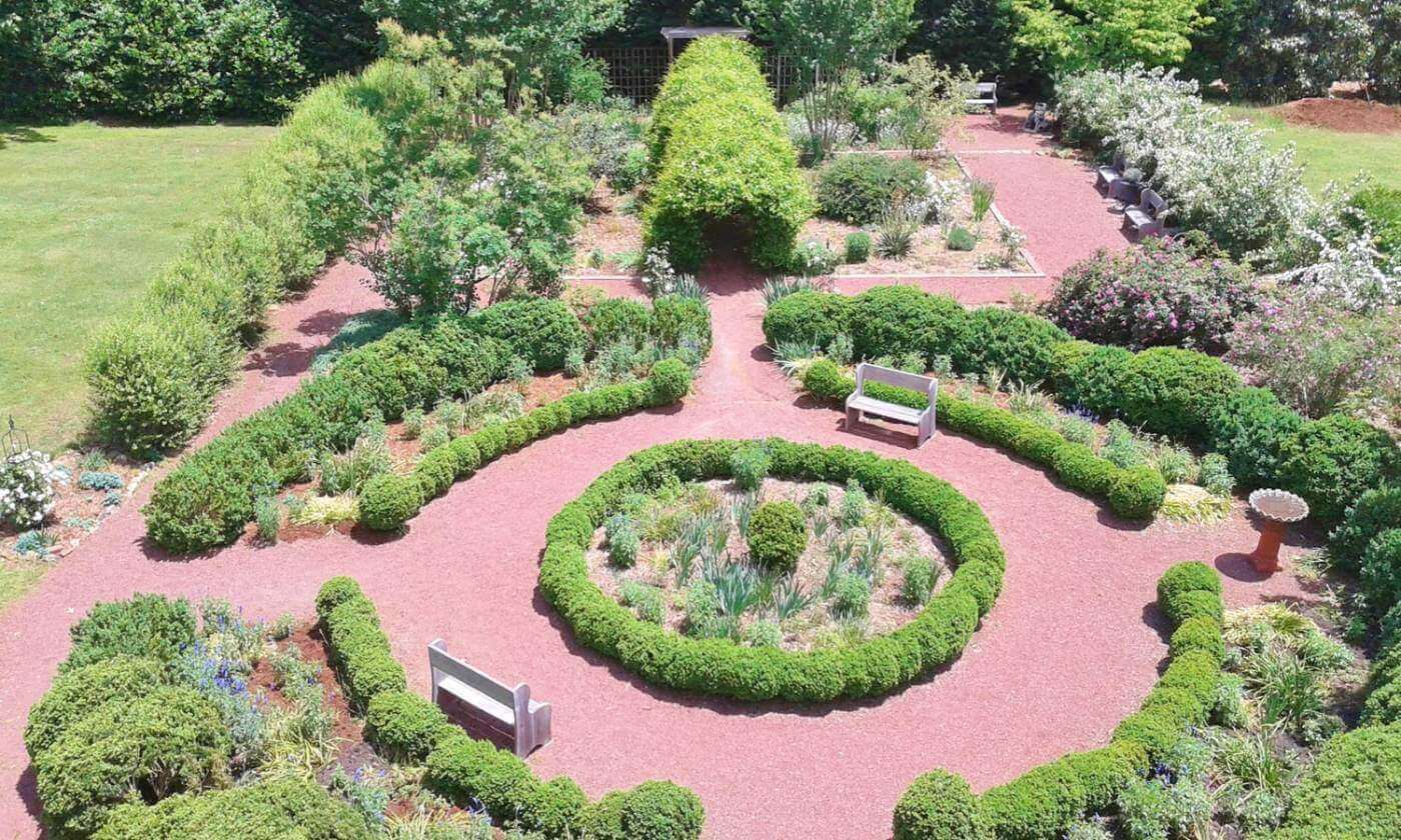 A circular garden with benches and trees