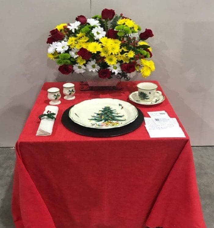 A table with a red cloth and some flowers
