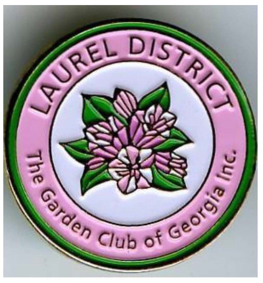 A pin with the name of laurel district and flowers.