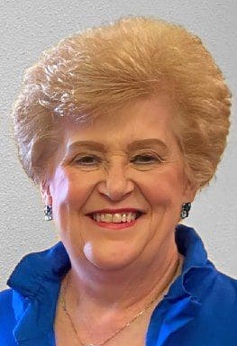Portrait of an elderly woman smiling.
