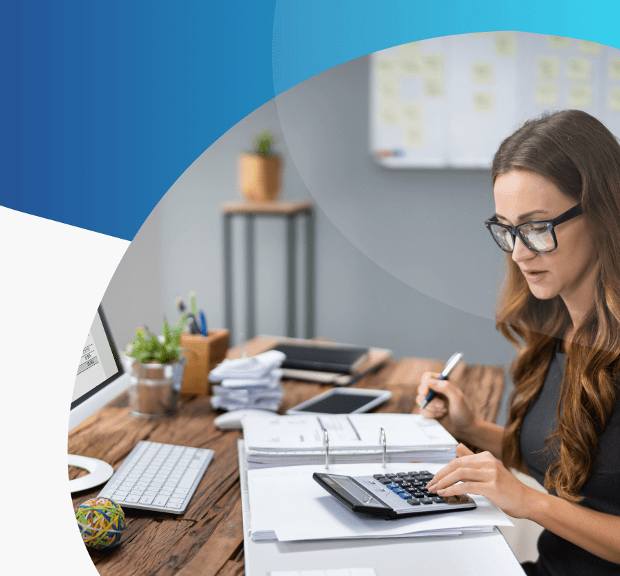 Woman working with calculator at desk.