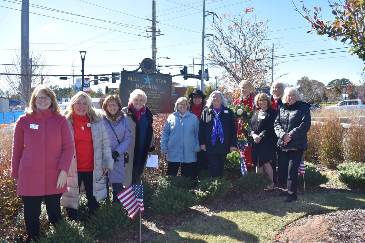 Members of Sandy Springs and Spalding Garden Club dedicate a BSM in Veterans Plaza across from Sandy Springs Performing Arts Center. 