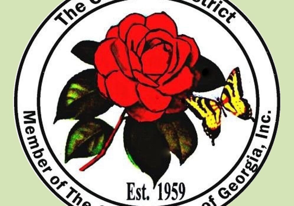 A red rose with a butterfly on it and the words " camellia district, member of the garden club of georgia inc."