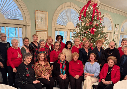 Women gathered beside decorated Christmas tree