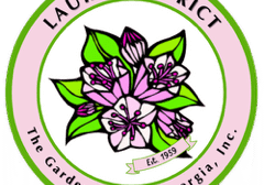 Circular logo with pink flowers and green leaves
